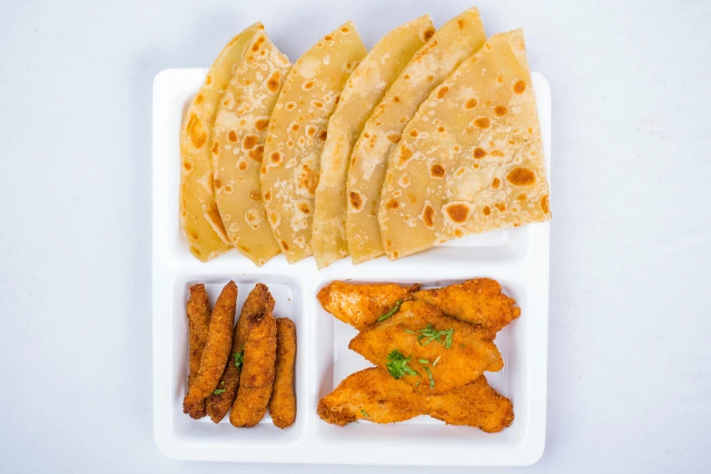 several types of food are in a white tray