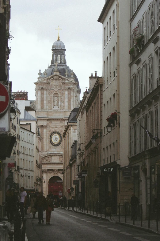 old buildings and pedestrians walking around the street