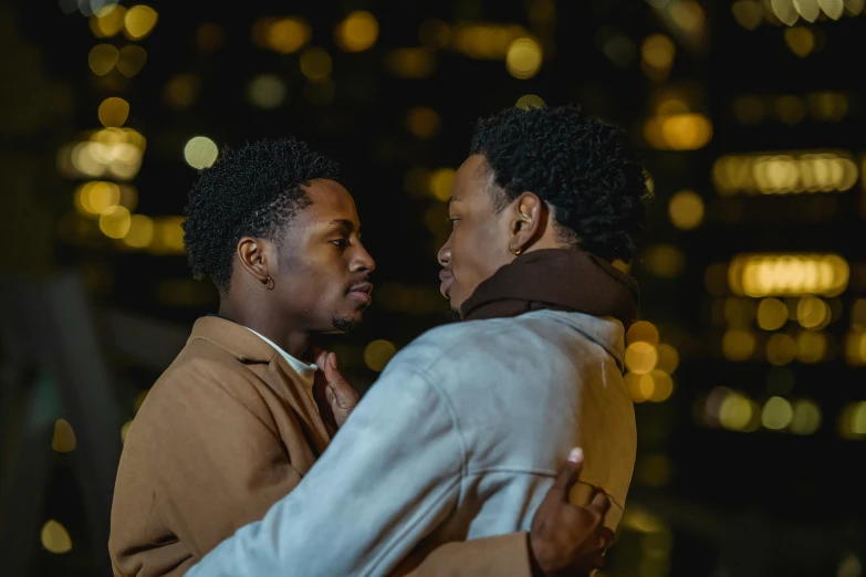 two people hug each other while standing in front of a city skyline