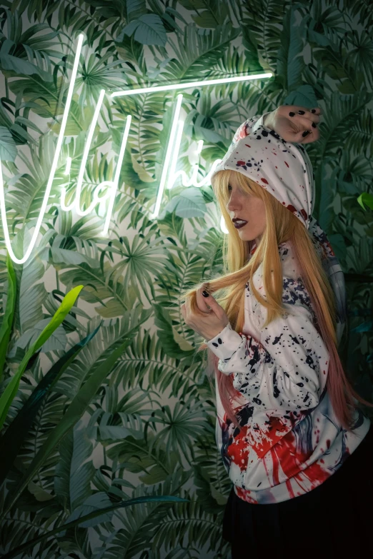 a girl stands next to a plant with the words wild above her