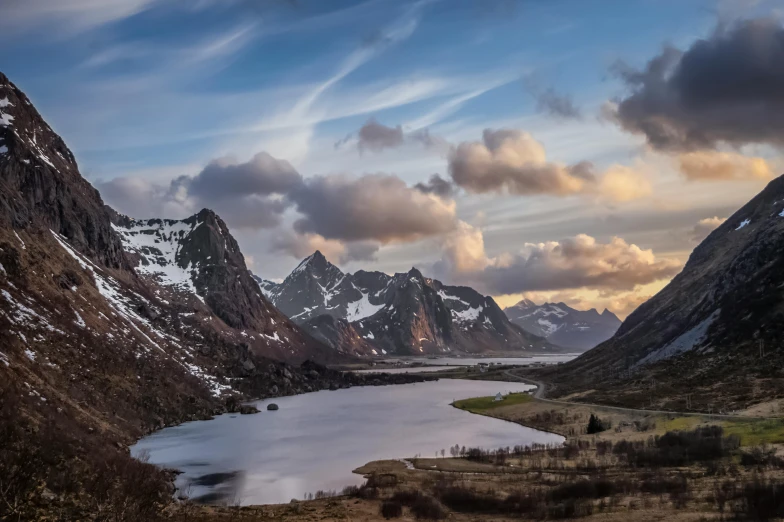 a group of mountains rise into a body of water in the middle of a mountainous area