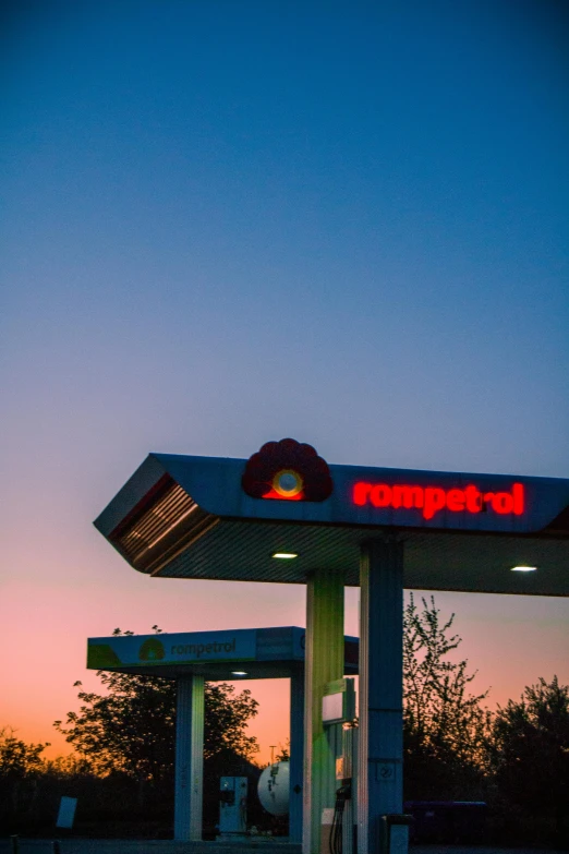 a car pump at sunset with an orange light at the top