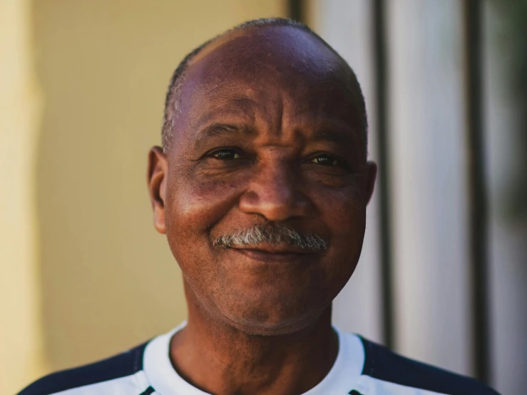 a man with a mustache posing for a picture