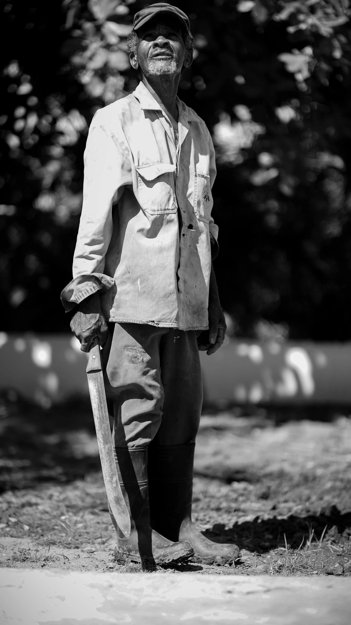 a man in cowboy clothing stands on the side of the road