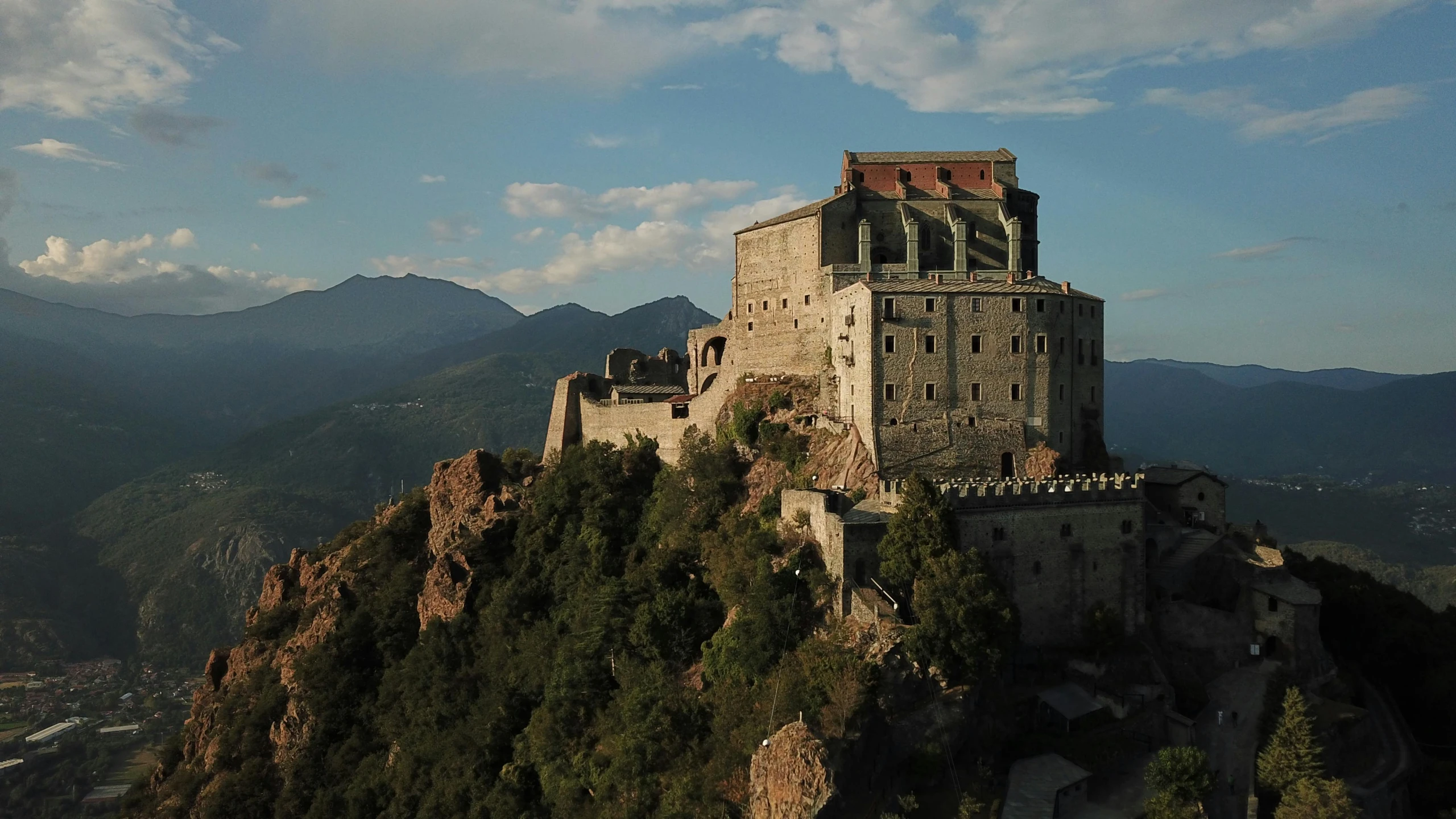 an old stone castle sitting on top of a mountain