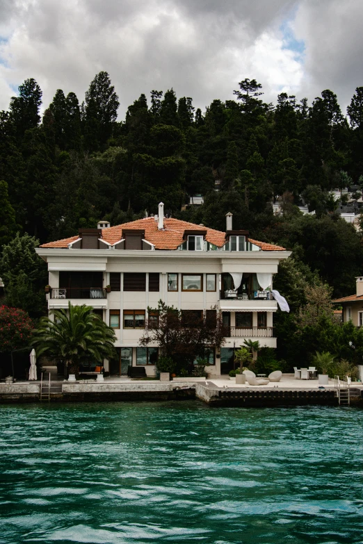 a white building on a beach next to the ocean