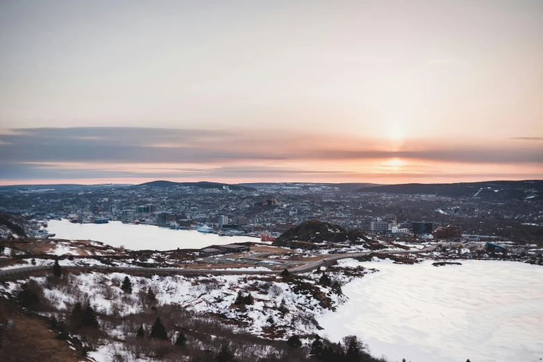 a snowy landscape with lake surrounded by hills