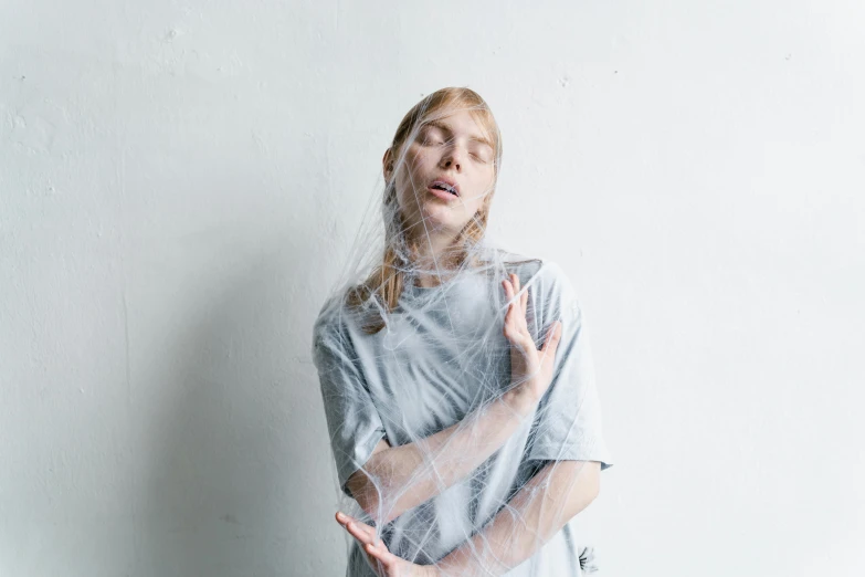 a woman with her face covered by transparent mesh