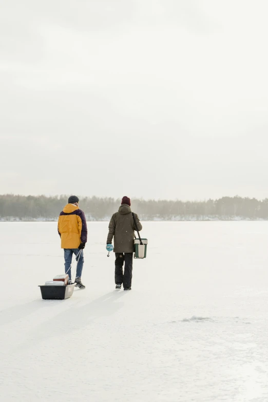 two people with baskets in the snow