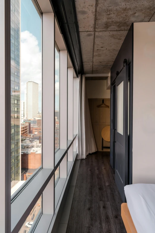 an open balcony view with a white bed and window