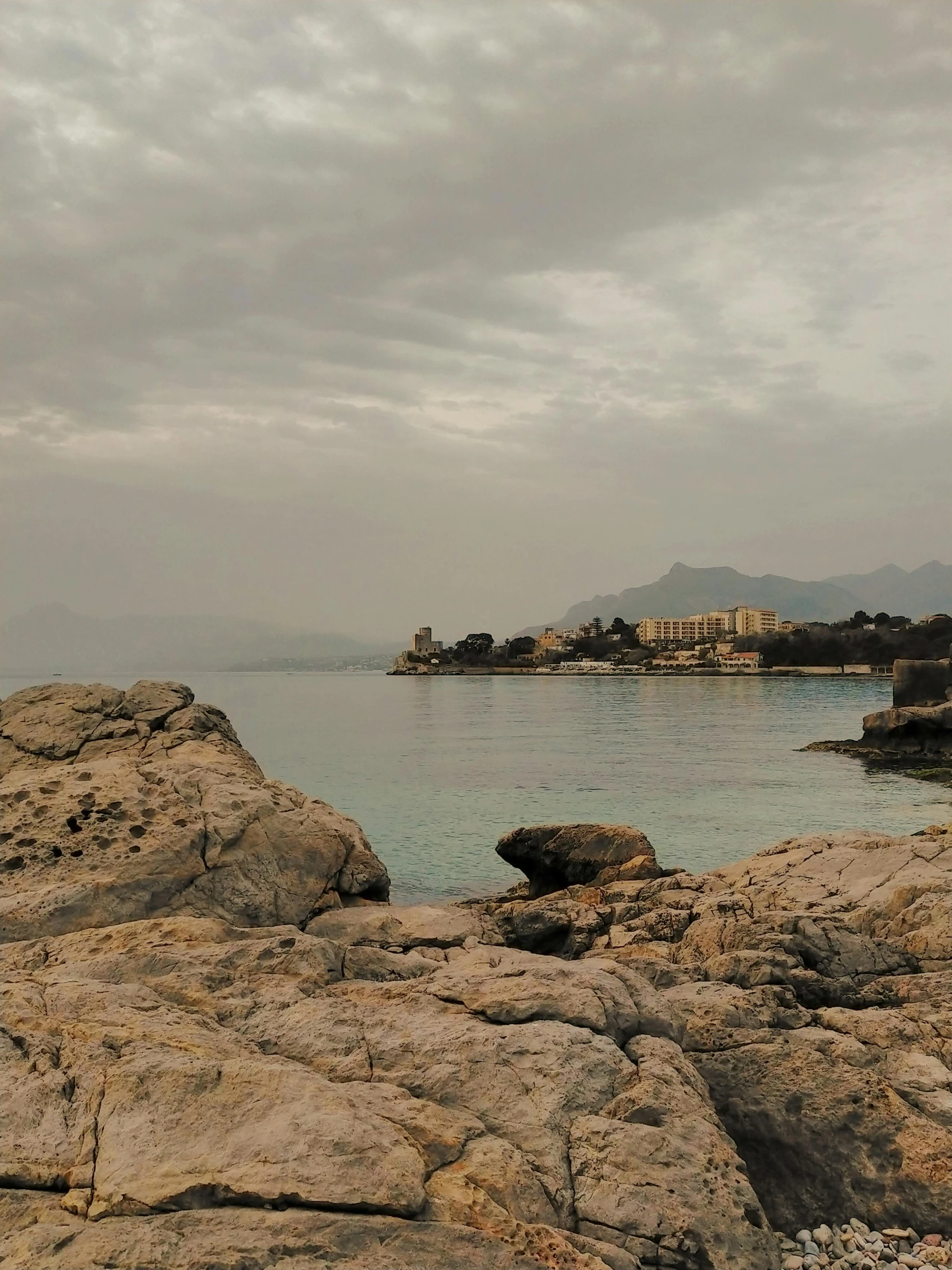 the view of some small buildings near the water