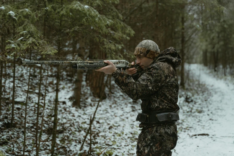 a man is shooting through the woods in winter