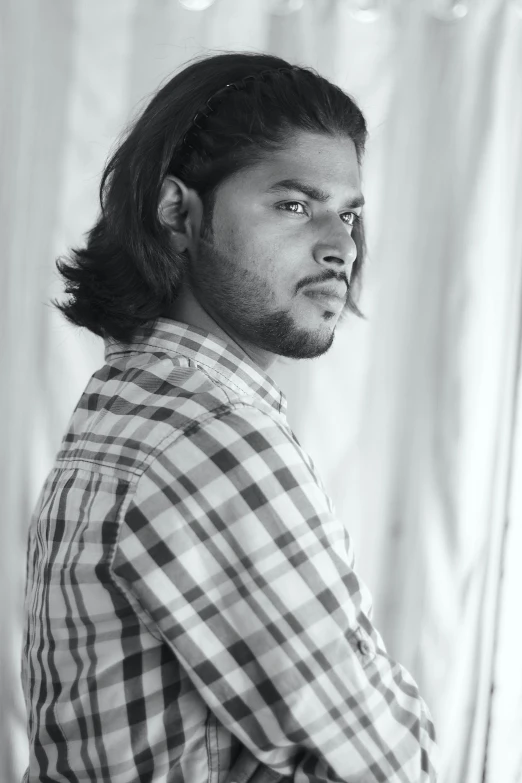 a young man with long hair and a shirt