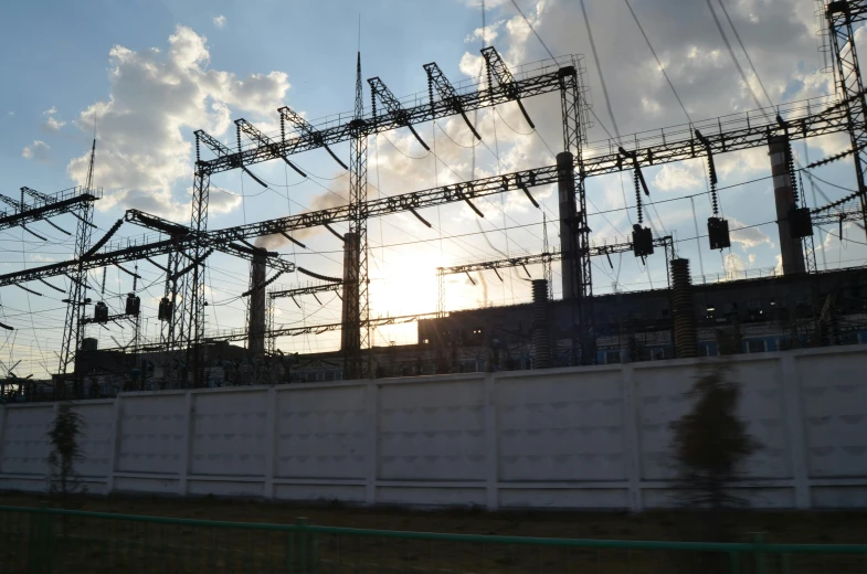 electric wires and sub station sunsets behind them