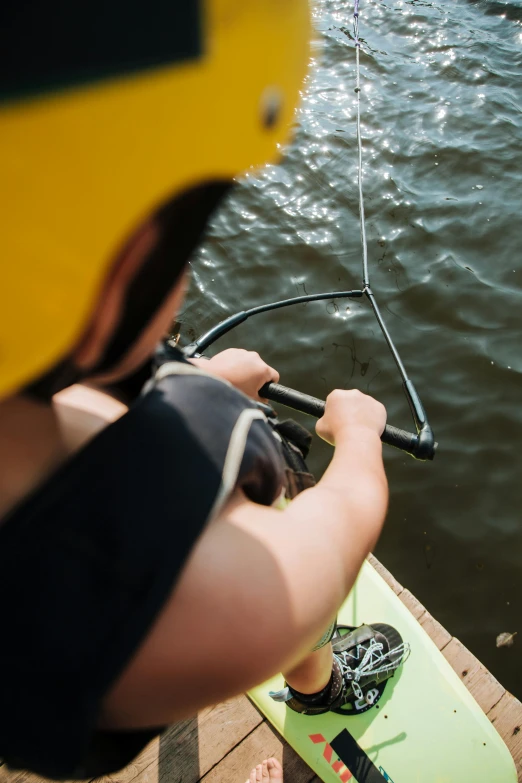 a person is holding the ropes of a boat near the water