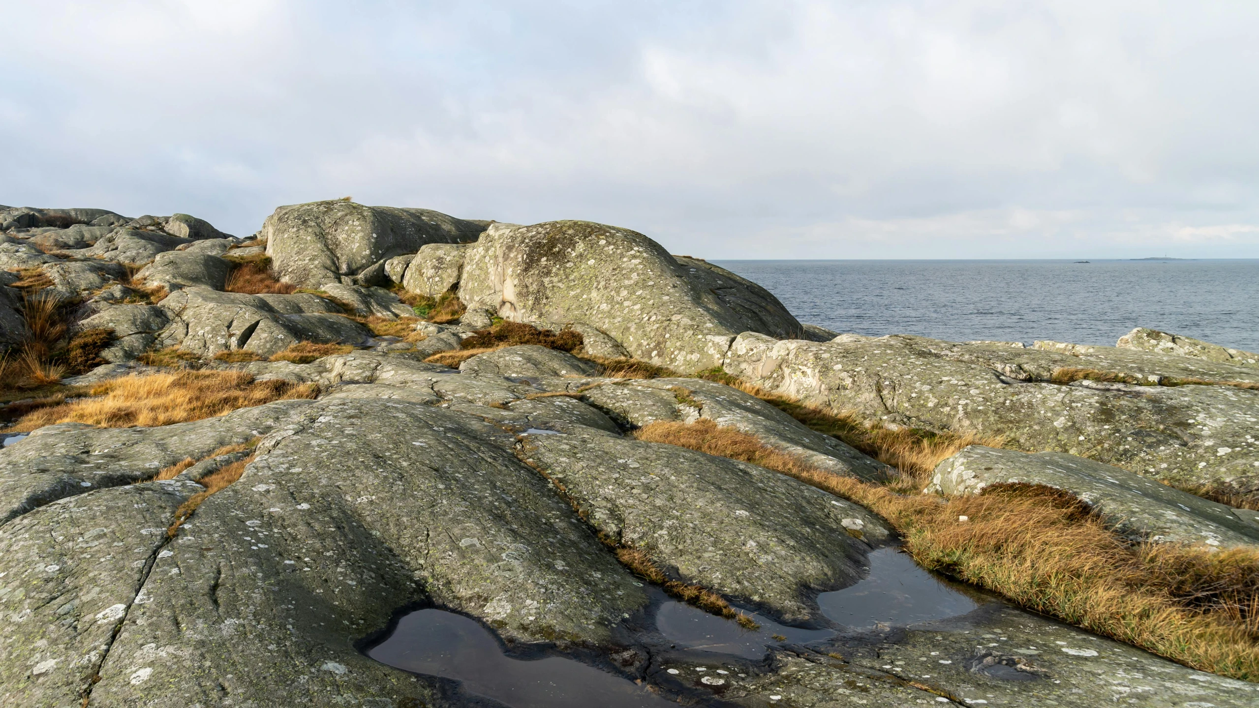 rocks that are standing near the ocean, and water