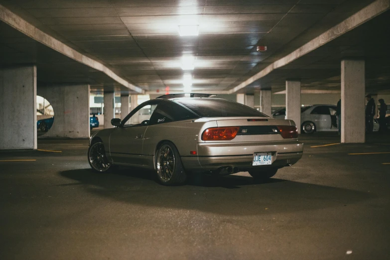 an empty parking garage with several cars and lights