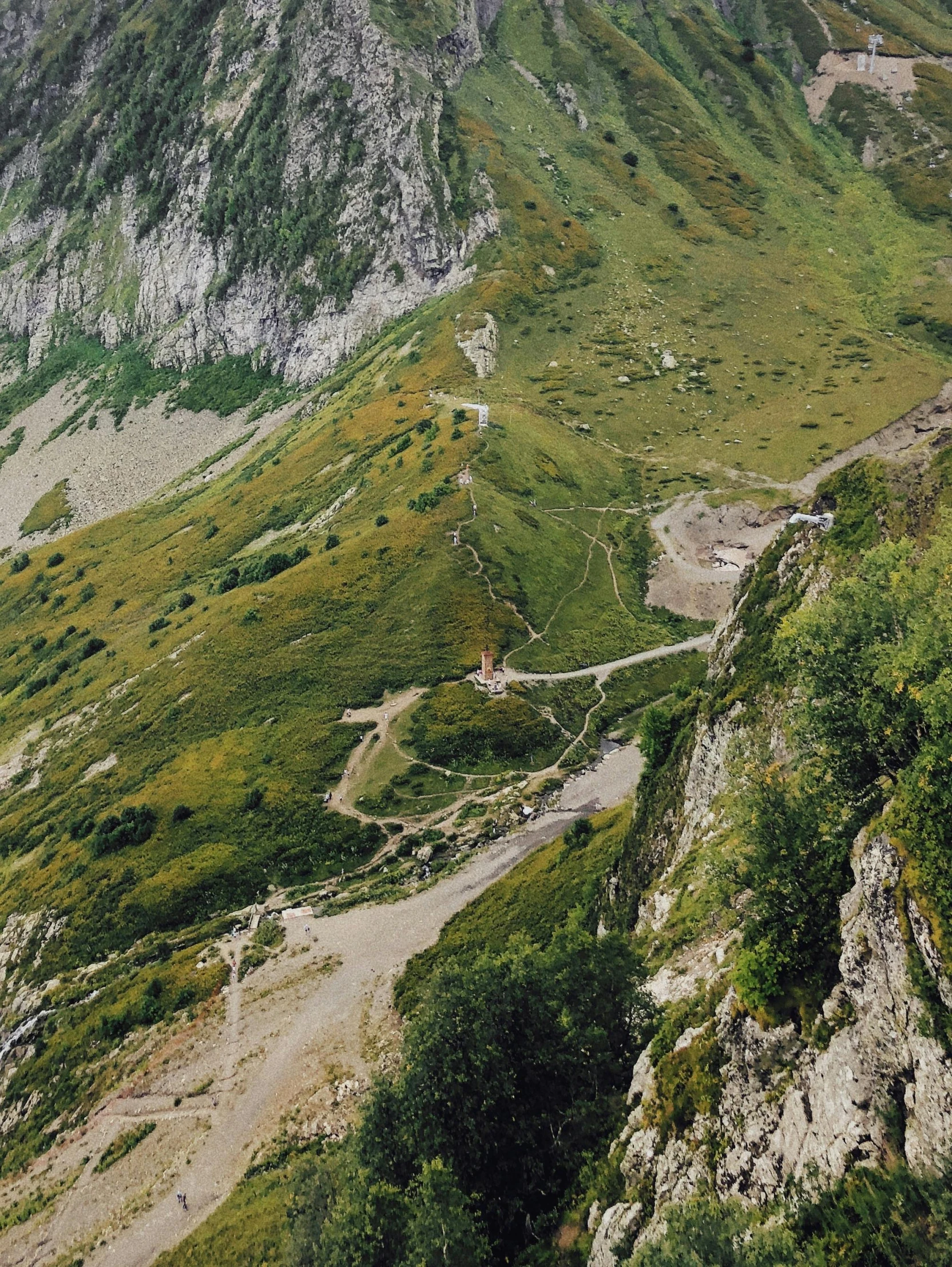 winding dirt road passing through hilly mountain area