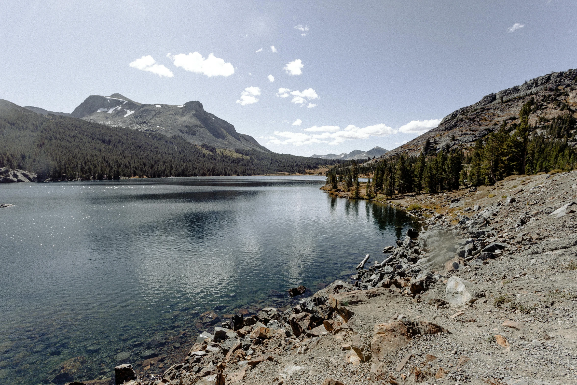 a scenic view from a rocky hill above a lake