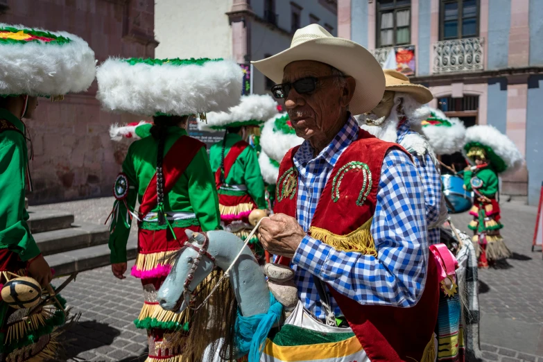 some people are wearing headdresses in a parade