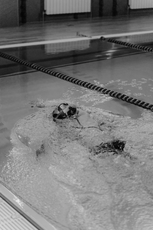 a swimmer swimming in a pool with his head submerged