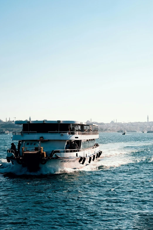 two boats riding through the water on top of the ocean