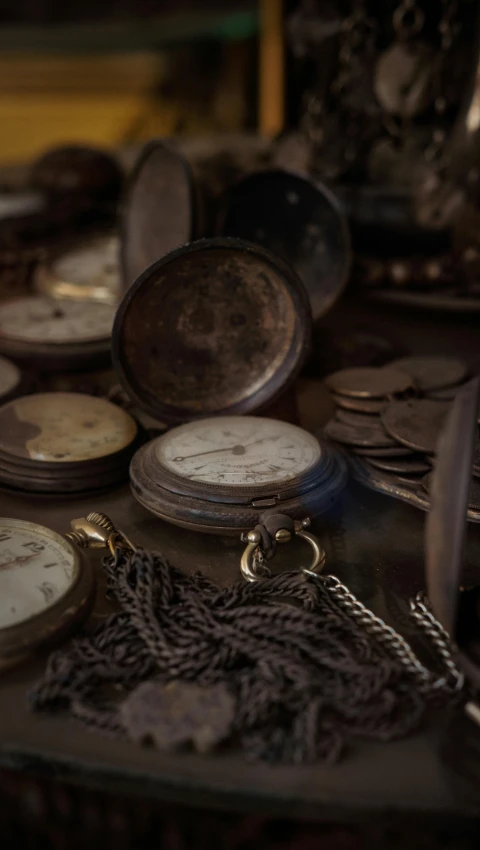 old wooden clocks and other watches on a table
