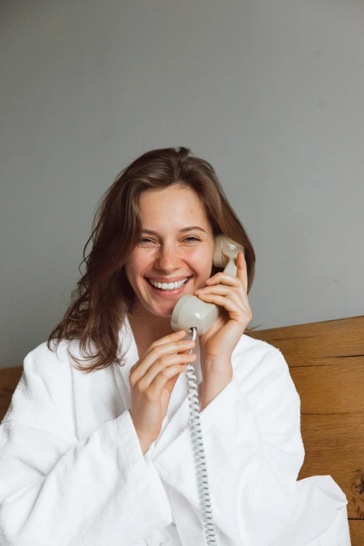 a woman is smiling and using a phone