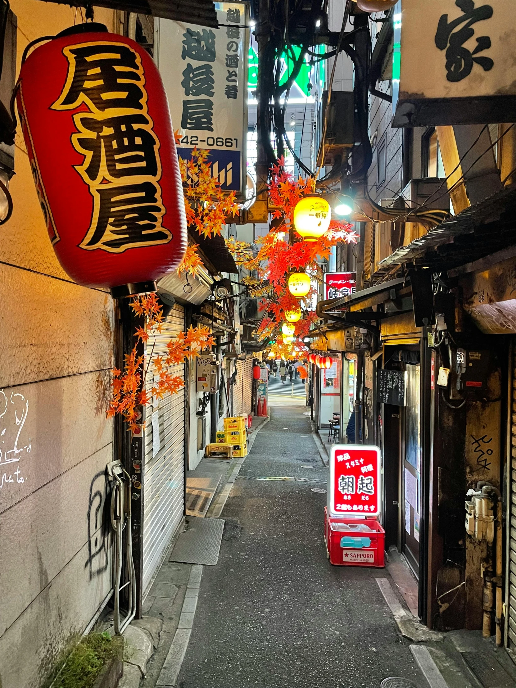 an alley way with some colorful lights and signs