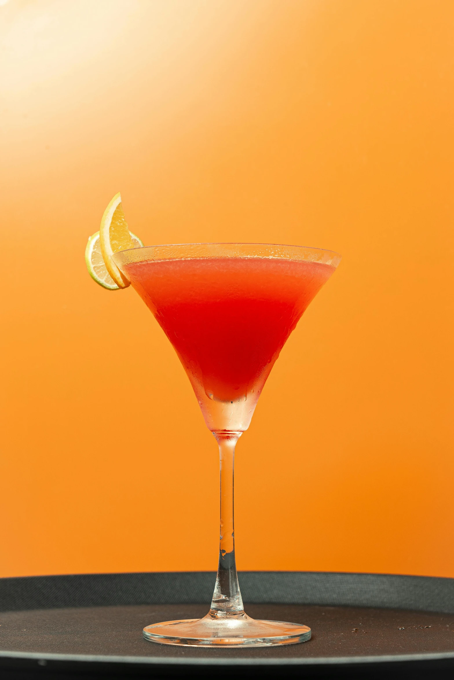 a fruit cocktail with a lemon wedge and orange