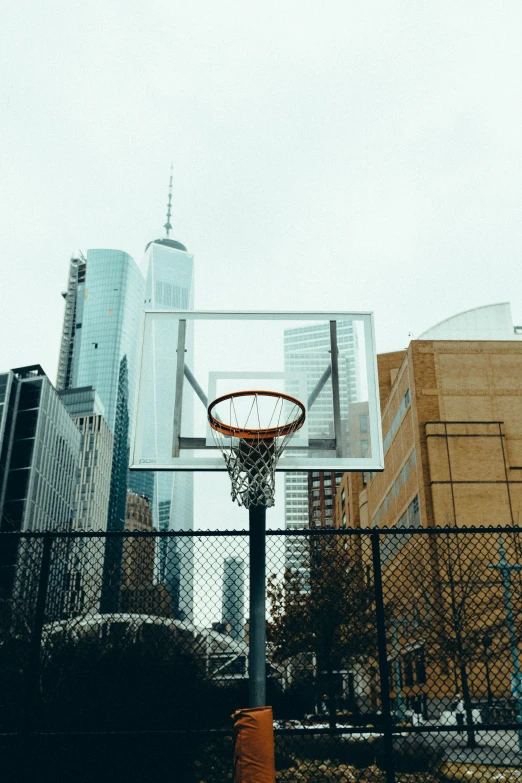 a basketball hoop with some buildings in the back ground