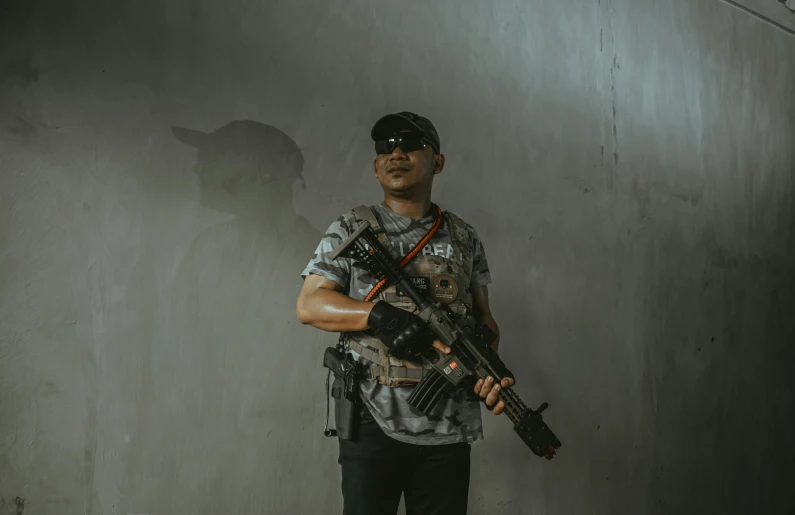 a man holding an automatic rifle with no recoil