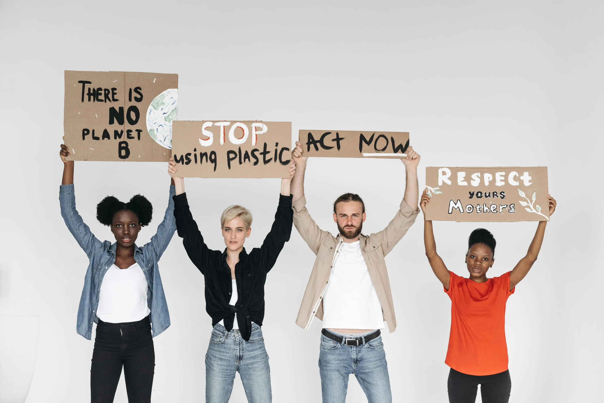 the group of people are holding signs on their shoulders