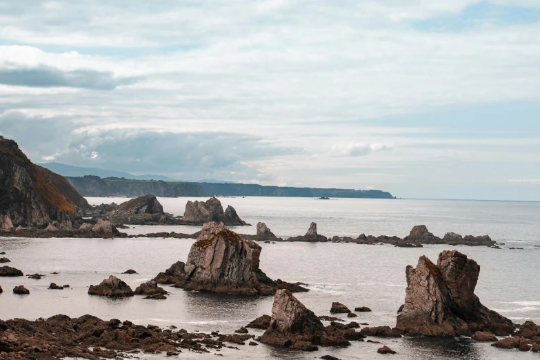 rocks on the shore near a calm ocean