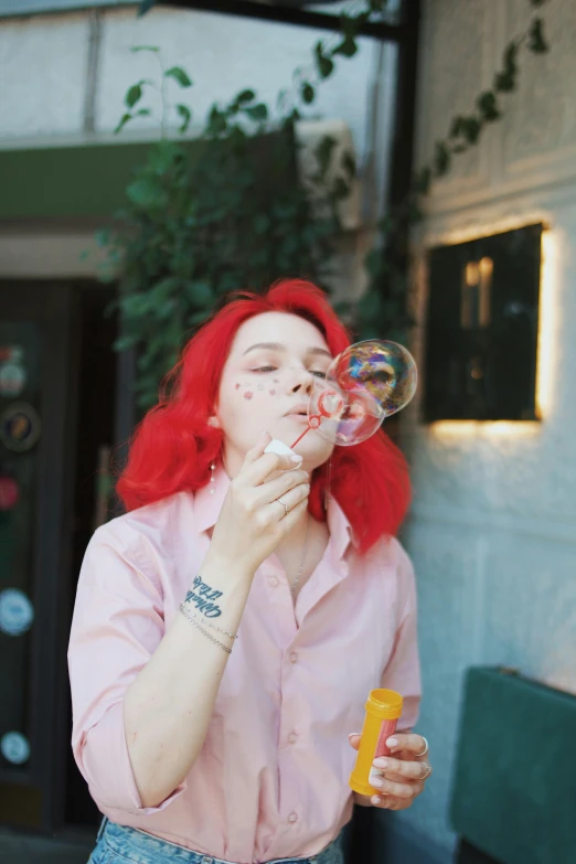 a young woman blowing bubbles with a yellow can