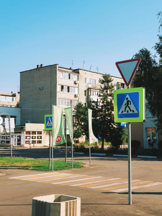 several street signs on post in front of buildings