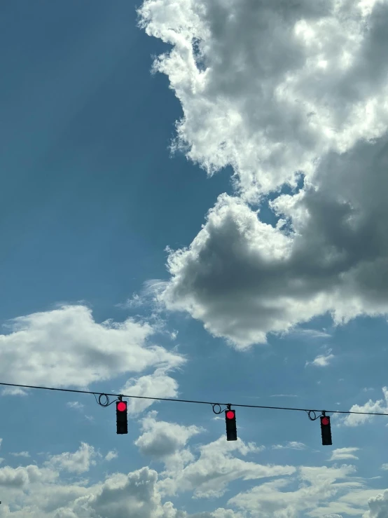 a sky with clouds and some red lights