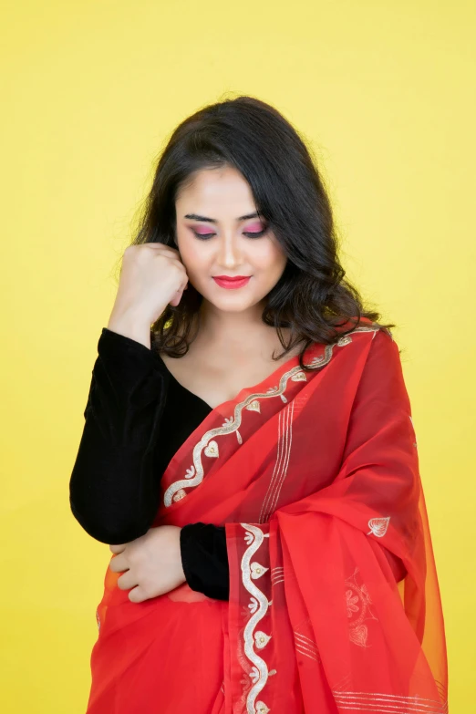 a beautiful woman standing in front of a yellow background