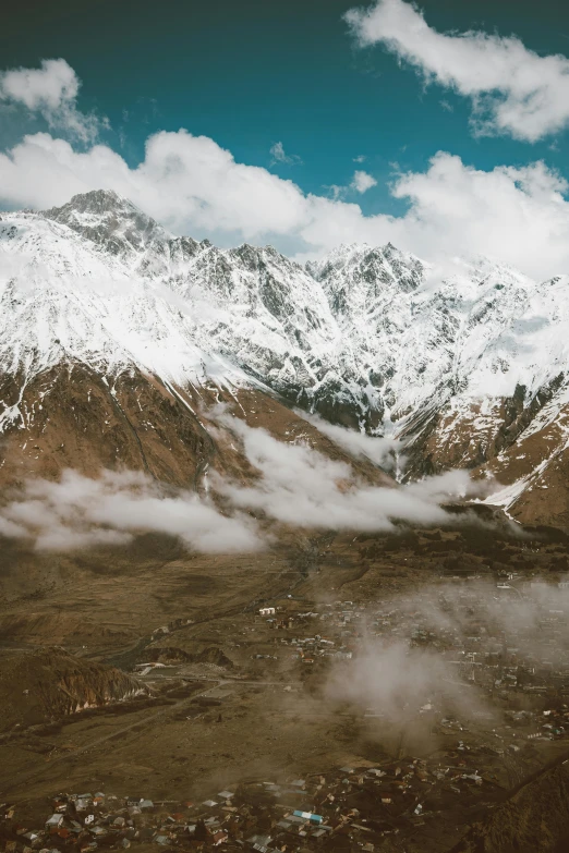 mountains in the distance are covered with clouds