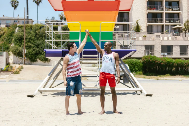 two s holding hands with each other on a beach