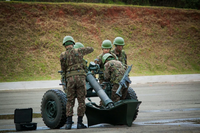 some men are putting on helmets while standing around a vehicle