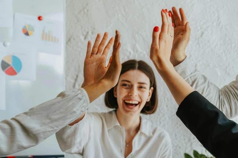 three people are giving each other the same hand