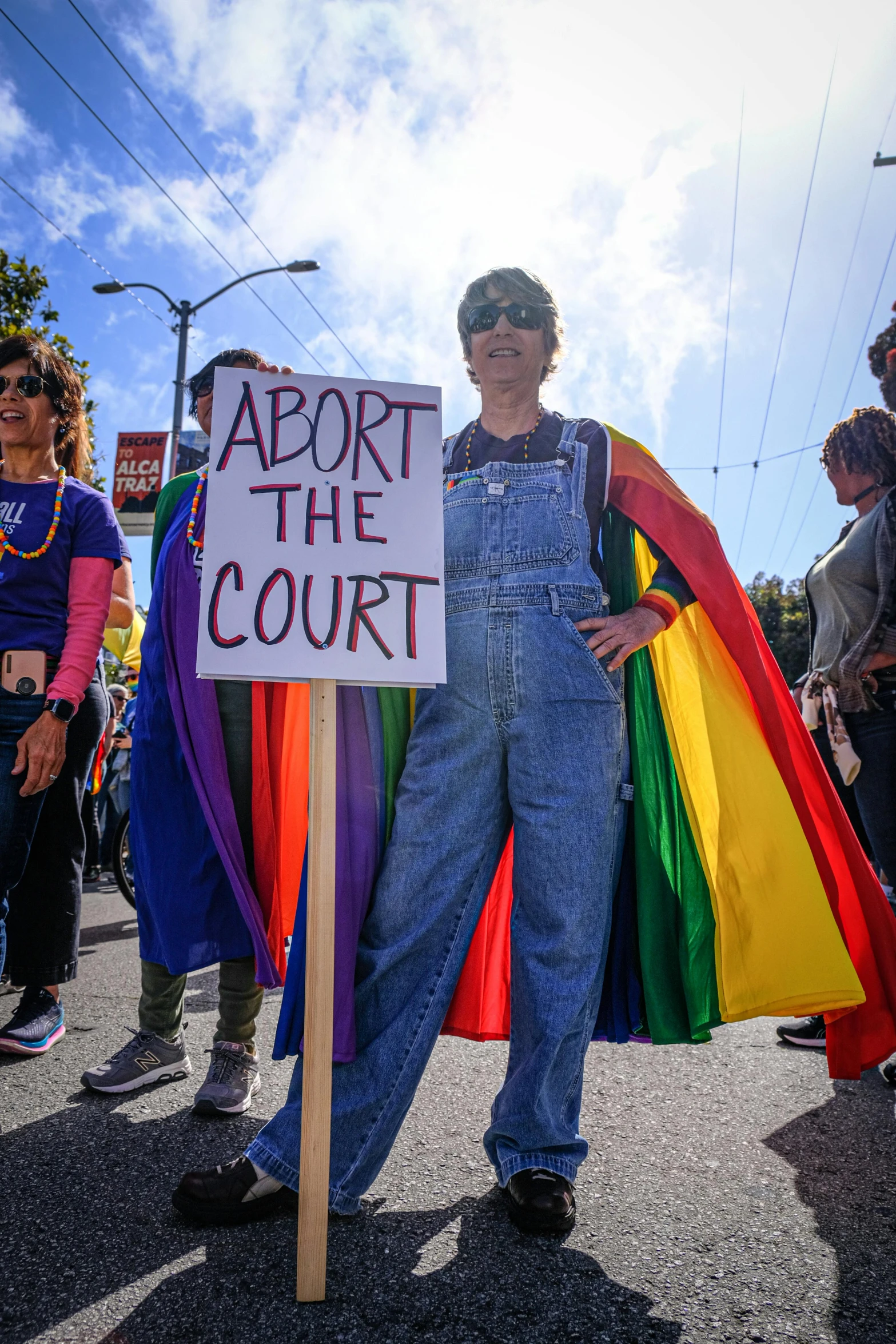 a man holding a sign in a crowd