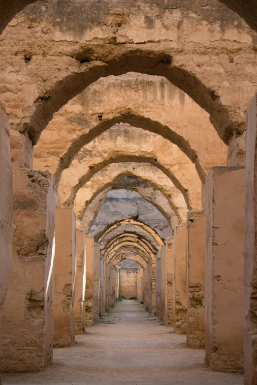 a stone building with columns and arches