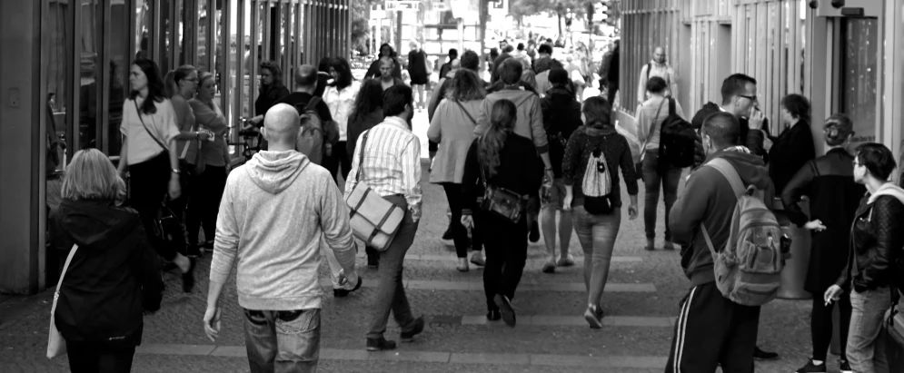 a group of people are walking on the street