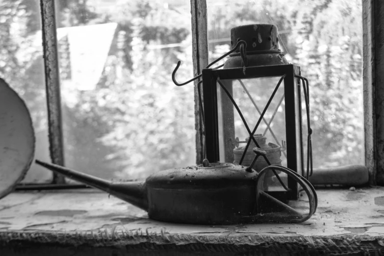 a glass lantern sitting on top of a windowsill