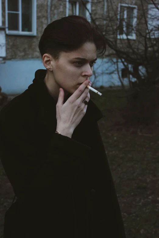 woman in black with cigarette in her mouth