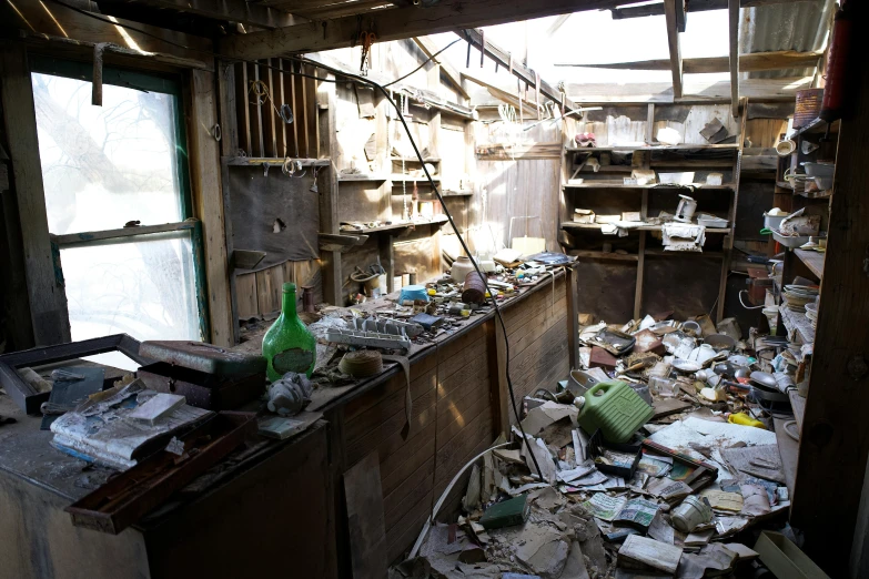 junk has piled in a room with many windows