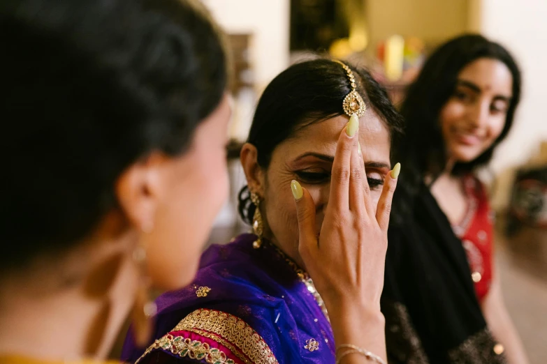 a woman who is holding her face up with a hand