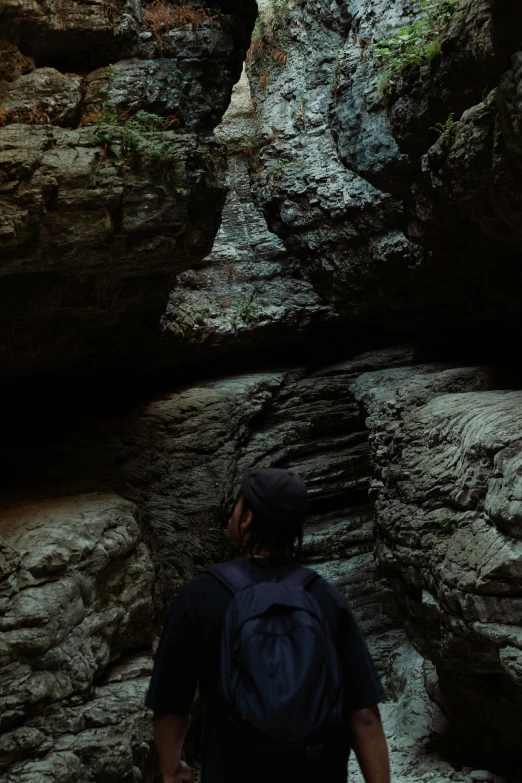 a person standing in a canyon with rocks